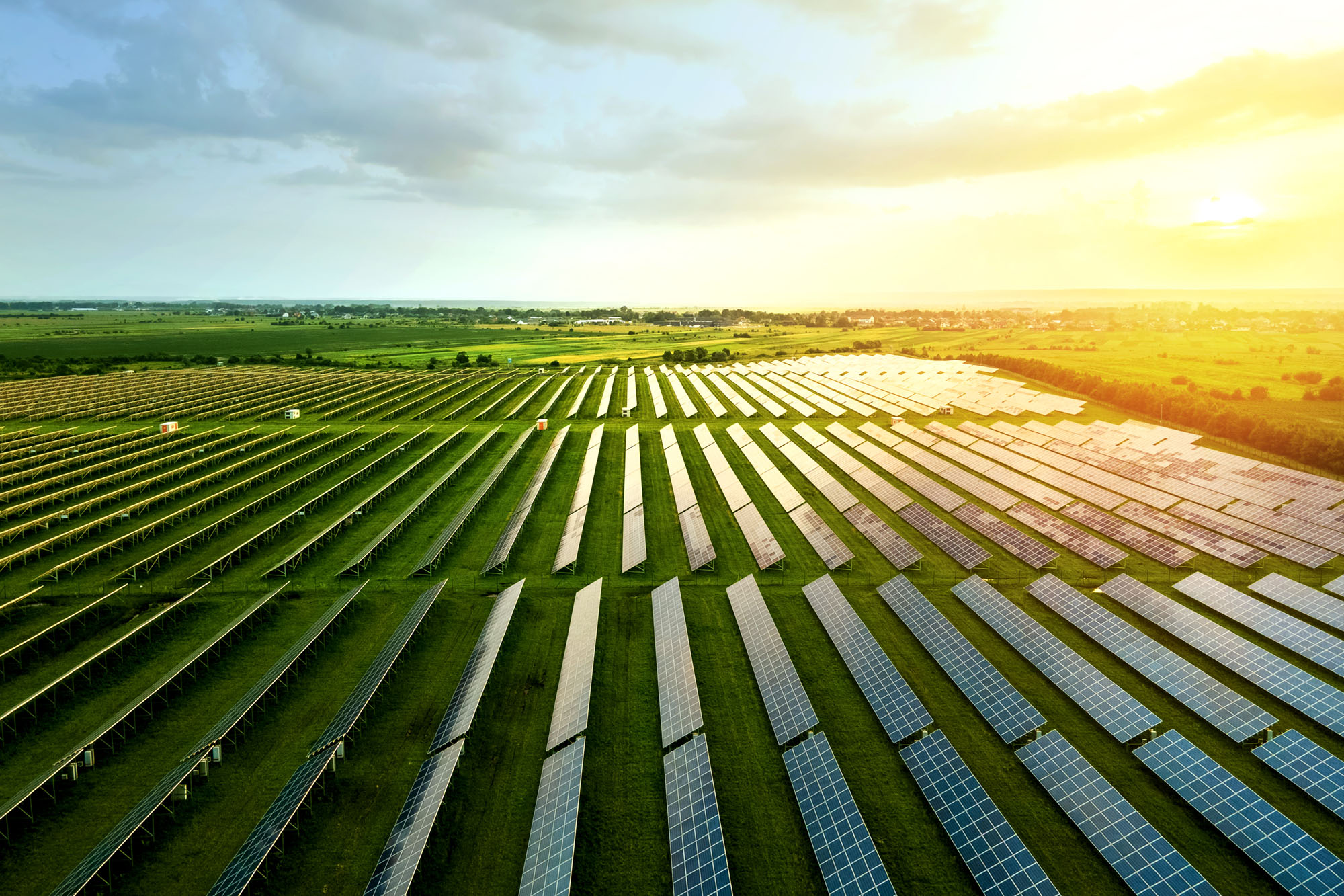 The sun sets over aerial view of a PureSky Energy solar farm.